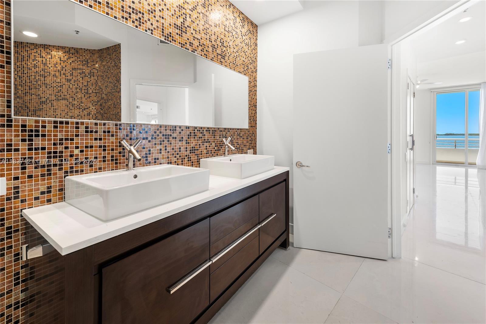 Brickell Miami, FL 33131 - Photo 43 of 65 a bathroom with a sink and a mirror