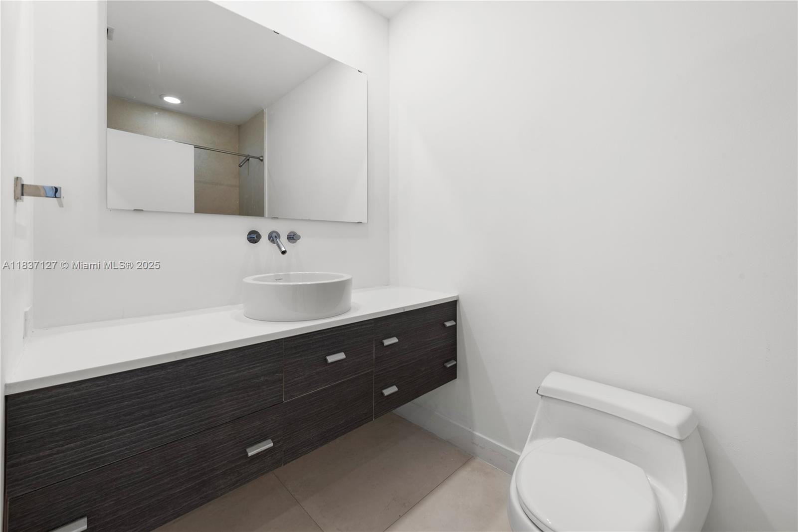 Brickell Miami, FL 33131 - Photo 55 of 65 a bathroom with a sink vanity mirror and toilet