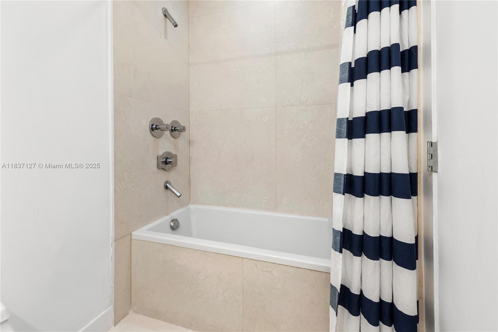 Brickell Miami, FL 33131 - Photo 56 of 65 a bathroom with a bathtub and shower