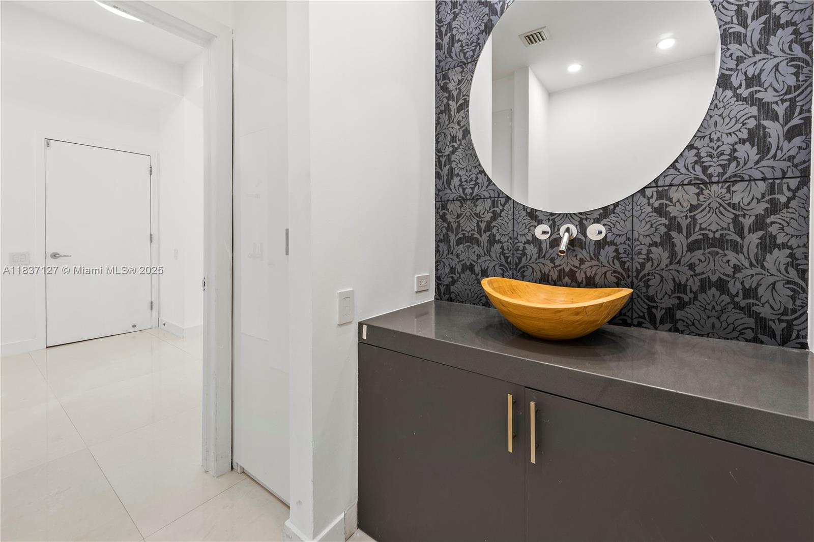 Brickell Miami, FL 33131 - Photo 57 of 65 a bathroom with a toilet and a mirror