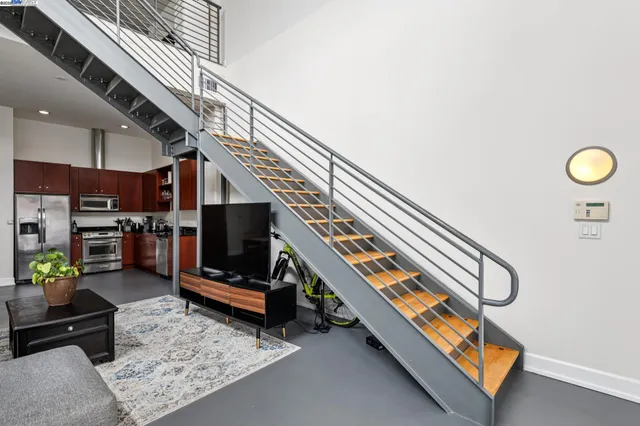 a living room with lots of furniture and a view of staircase