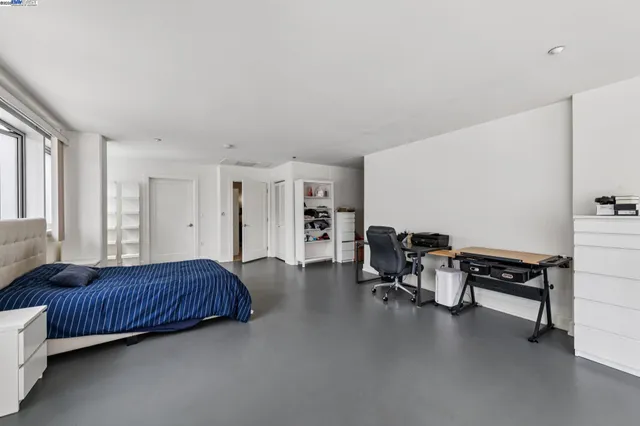 a bedroom with a large bed and a window