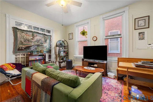a living room with furniture and a flat screen tv