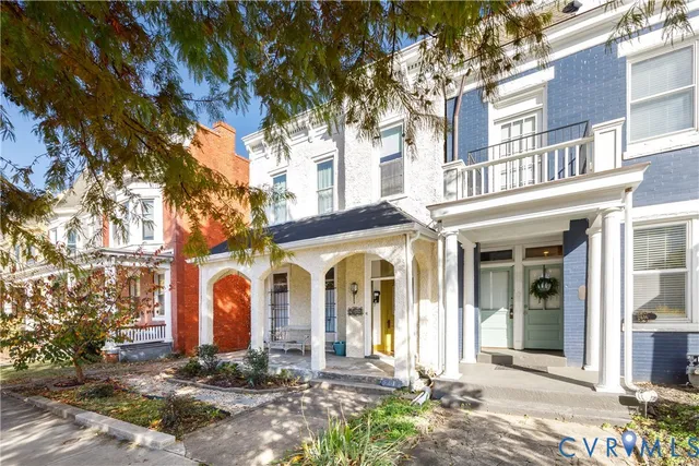 front view of a brick house with a yard