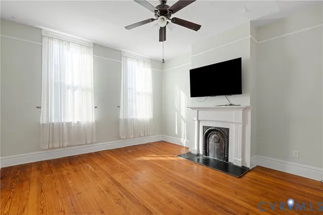 a view of empty room with fireplace and fan