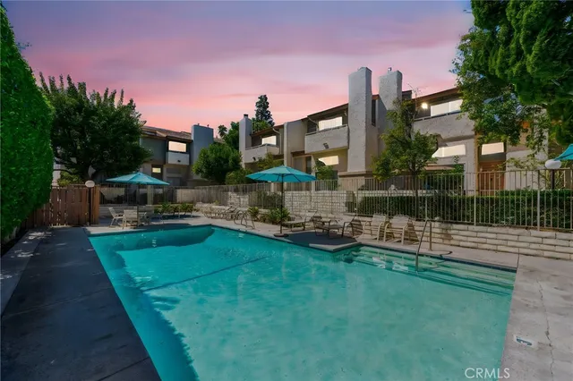 a view of a house with backyard porch and sitting area