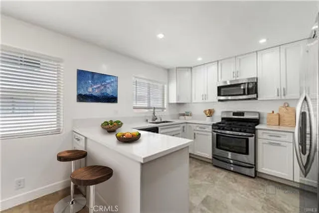 a kitchen with a sink a stove and cabinets