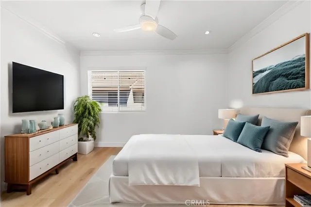 a bedroom with a flat screen television and a bed