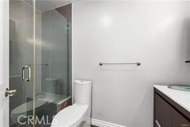 a bathroom with a shower and toilet