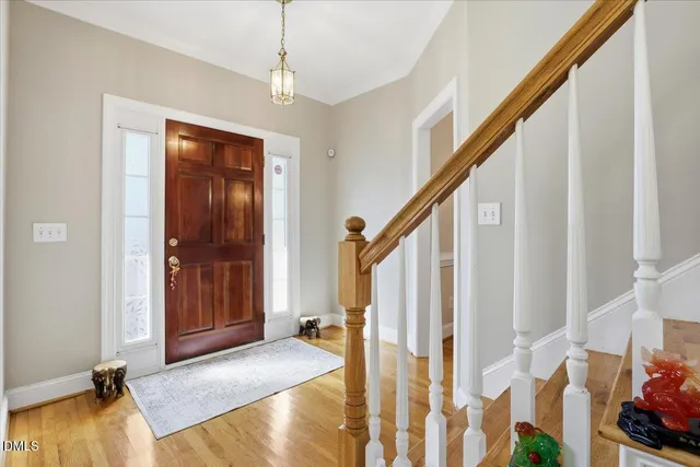 a kitchen with stainless steel appliances granite countertop a stove top oven a refrigerator a sink and dishwasher with wooden floor