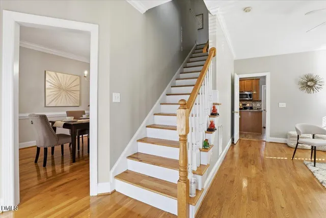 a kitchen with stainless steel appliances granite countertop a refrigerator a stove and a sink with wooden floor