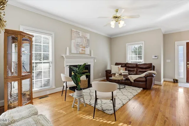 a kitchen with stainless steel appliances granite countertop a stove top oven a sink dishwasher a dining table and chairs with wooden floor