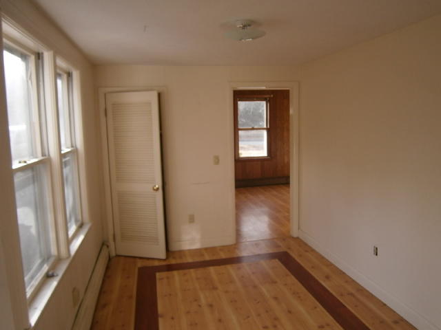 867 Shore Road Pocasset, MA 02559 - Photo 4 of 16 a view of a livingroom with wooden floor and a window