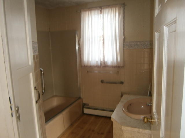 867 Shore Road Pocasset, MA 02559 - Photo 8 of 16 a bathroom with a tub a window and a sink