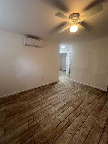 a view of a room with wooden floor and fan