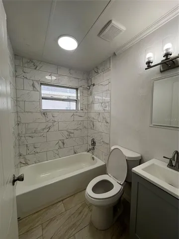 a bathroom with a toilet a sink and bathtub
