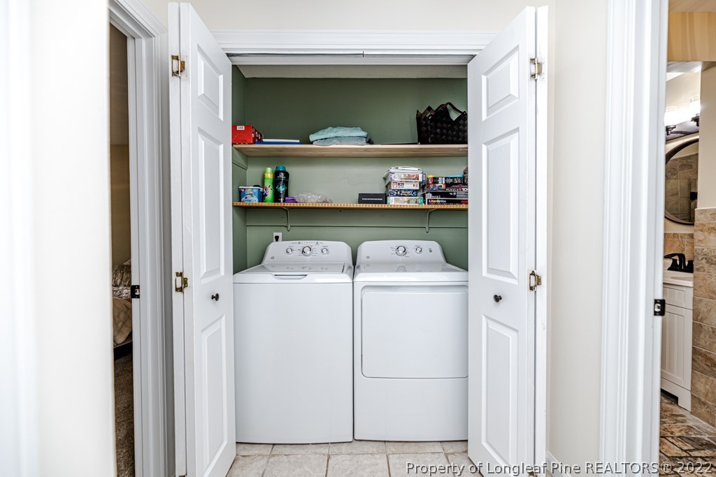 110 Cypress Road Cameron, NC 28326 - Photo 17 of 35 a view of washer and dryer with kitchen in the background