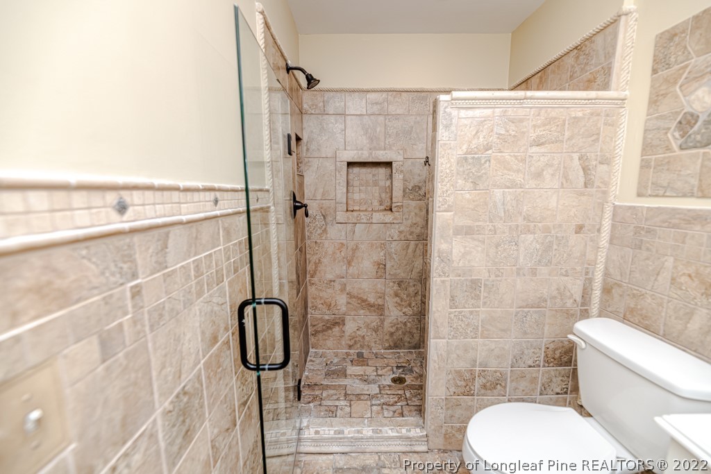 110 Cypress Road Cameron, NC 28326 - Photo 20 of 35 a bathroom with a toilet and shower