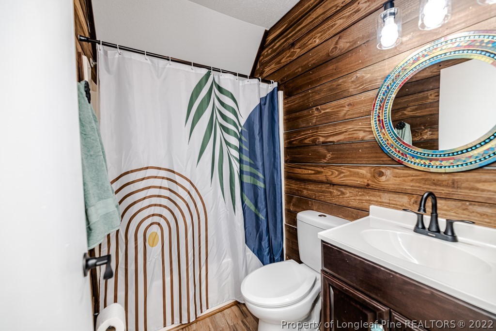 110 Cypress Road Cameron, NC 28326 - Photo 23 of 35 a bathroom with a sink a toilet and a mirror