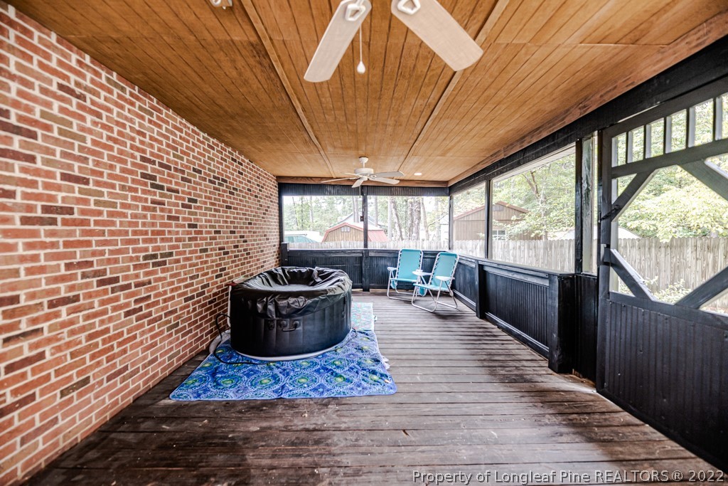 110 Cypress Road Cameron, NC 28326 - Photo 26 of 35 a living room with a couch wooden floor and a potted plant