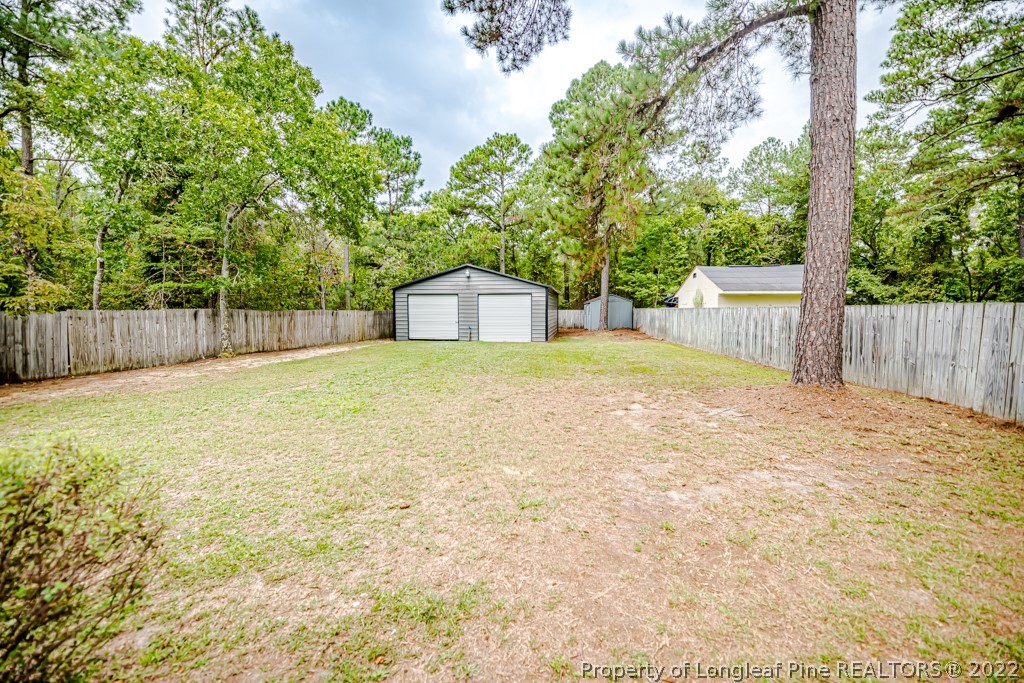 110 Cypress Road Cameron, NC 28326 - Photo 27 of 35 a view of a backyard with large trees and wooden fence