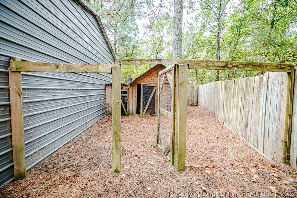 110 Cypress Road Cameron, NC 28326 - Photo 30 of 35 a view of a pathway of a house with wooden fence
