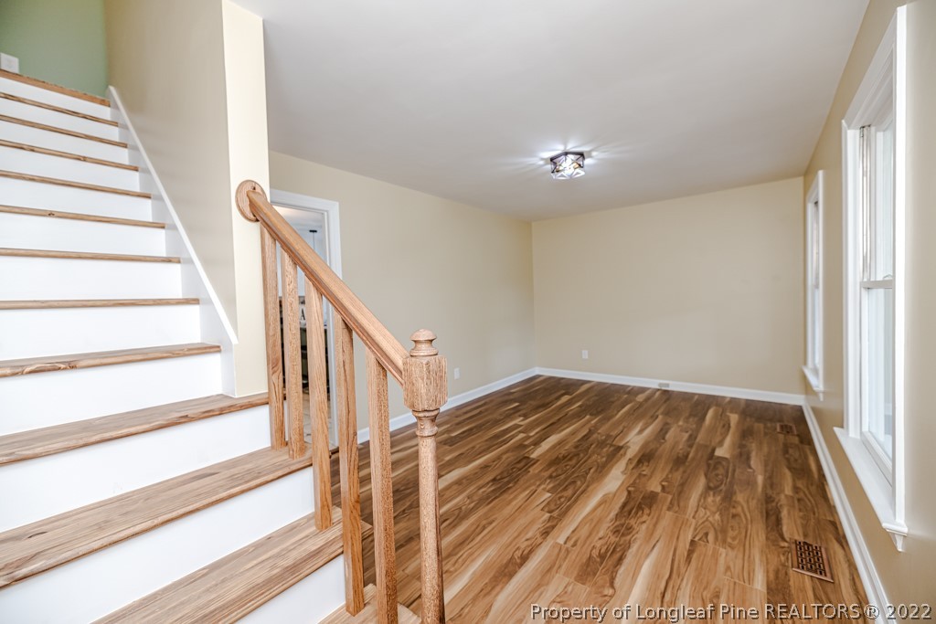 110 Cypress Road Cameron, NC 28326 - Photo 8 of 35 a view of a hallway with wooden floor and staircase