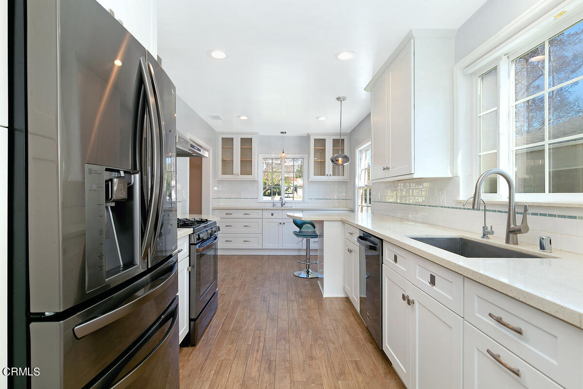 1060 West Roses Road San Gabriel, CA 91775 - Photo 4 of 12 a kitchen with stainless steel appliances sink a stove and cabinets