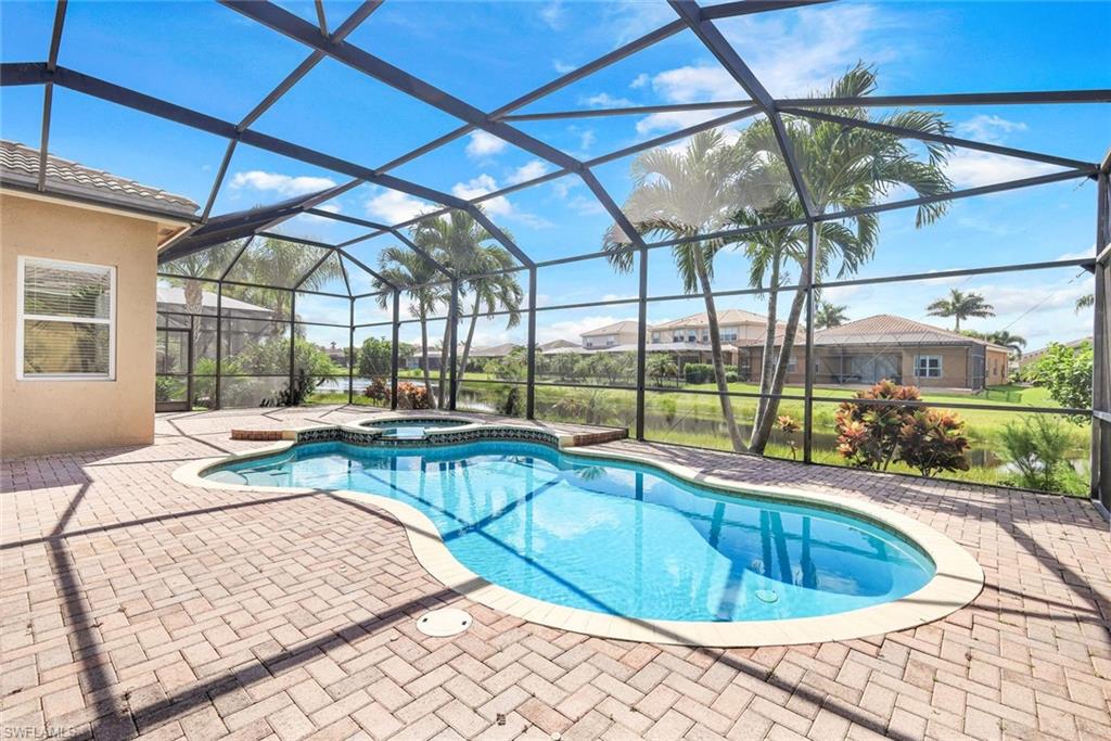 6592 Marbella Lane Naples, FL 34105 - Photo 14 of 18 a view of a swimming pool with a patio