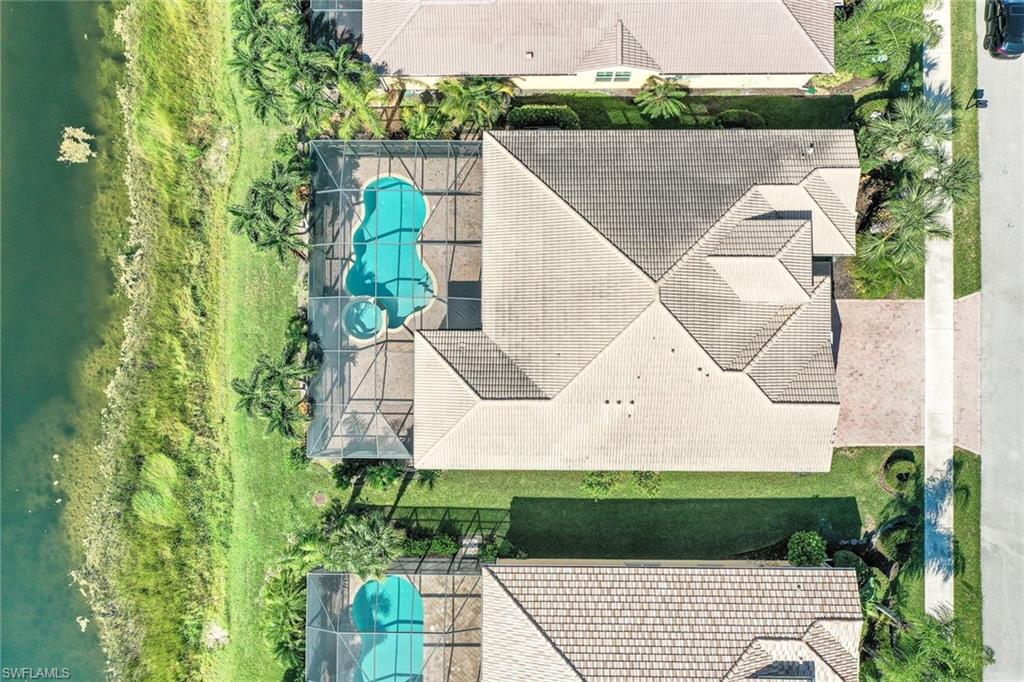 6592 Marbella Lane Naples, FL 34105 - Photo 17 of 18 a aerial view of a house with a yard and potted plants