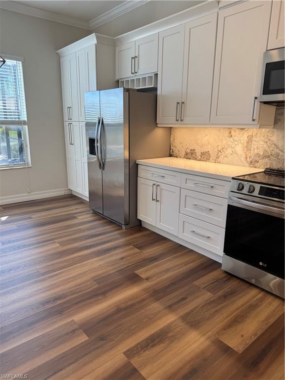 6592 Marbella Lane Naples, FL 34105 - Photo 8 of 18 a kitchen with a refrigerator stove and wooden cabinets