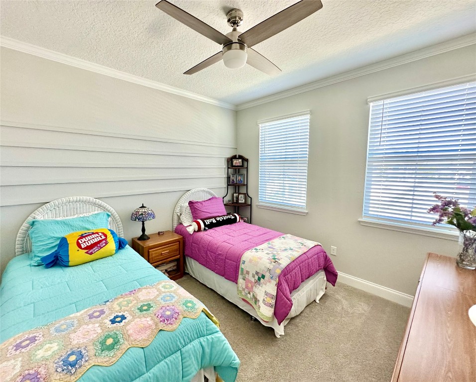 323 Sweetgum Street Yulee, FL 32097 - Photo 14 of 29 a bedroom with two beds and a couch