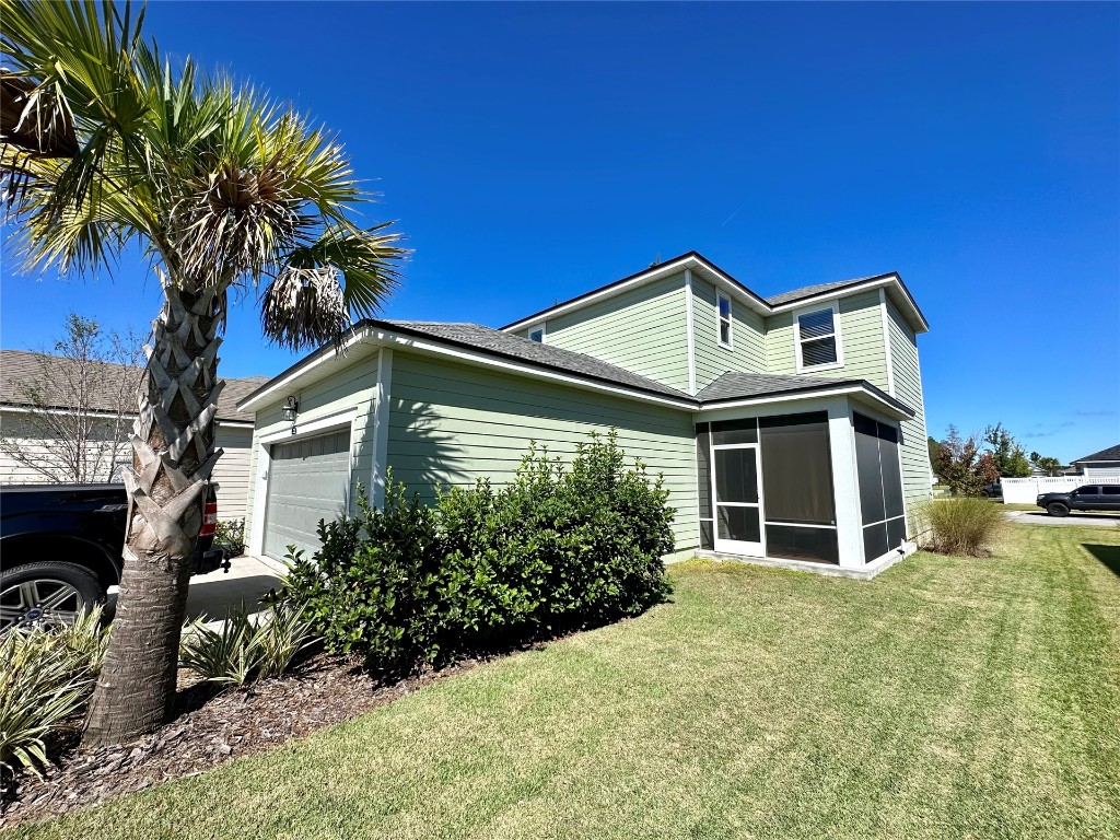 323 Sweetgum Street Yulee, FL 32097 - Photo 18 of 29 a front view of a house with a yard
