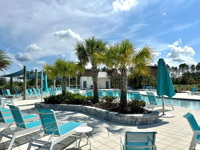 a view of a swimming pool with a patio and swimming pool