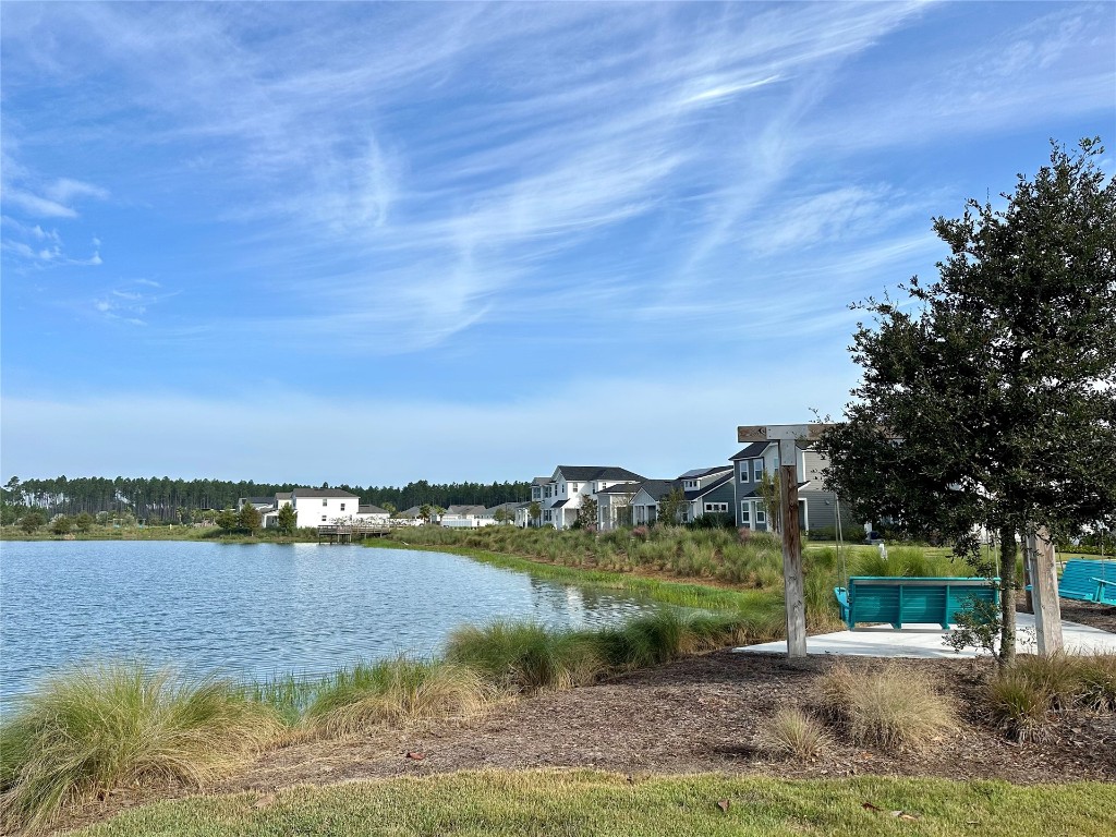 323 Sweetgum Street Yulee, FL 32097 - Photo 23 of 29 a view of a lake with houses in the back