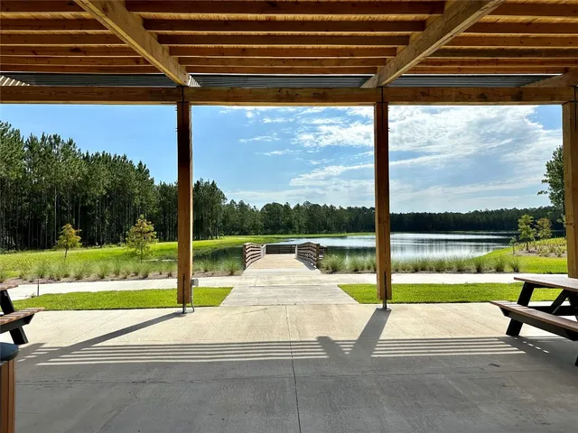 a view of a lake with boats and trees in the background