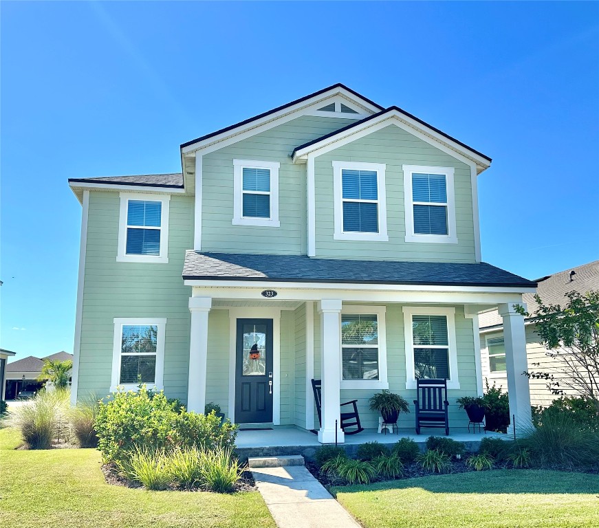 323 Sweetgum Street Yulee, FL 32097 - Photo 28 of 29 a front view of a house with garden and porch