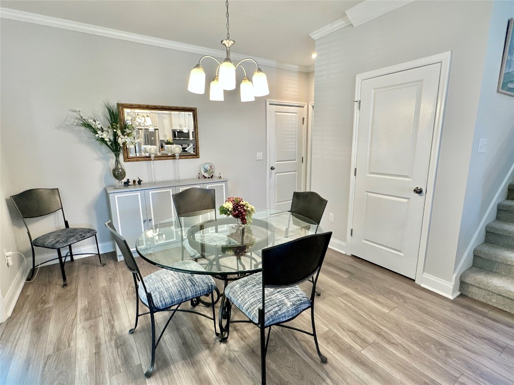 323 Sweetgum Street Yulee, FL 32097 - Photo 7 of 29 a view of a dining room with furniture and wooden floor