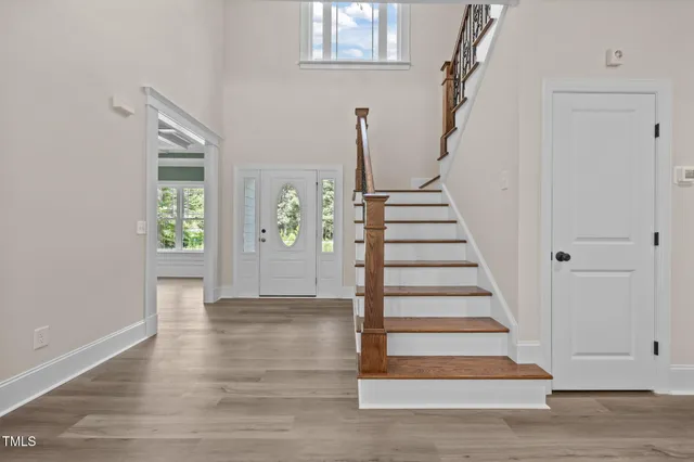 wooden floor fireplace and windows in an empty room