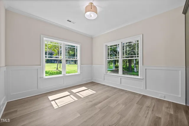 a bathroom with a granite countertop sink a toilet and a window