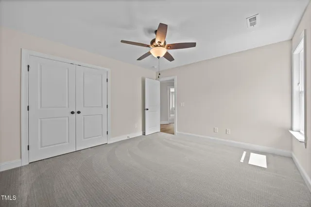 a white house that has a tree in front of it