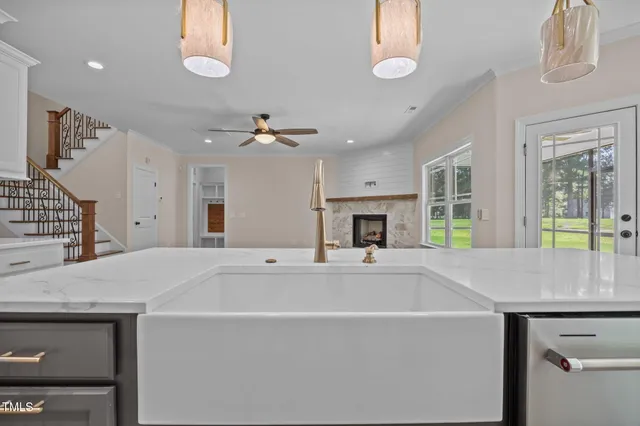 a kitchen with stainless steel appliances a sink stove and cabinets