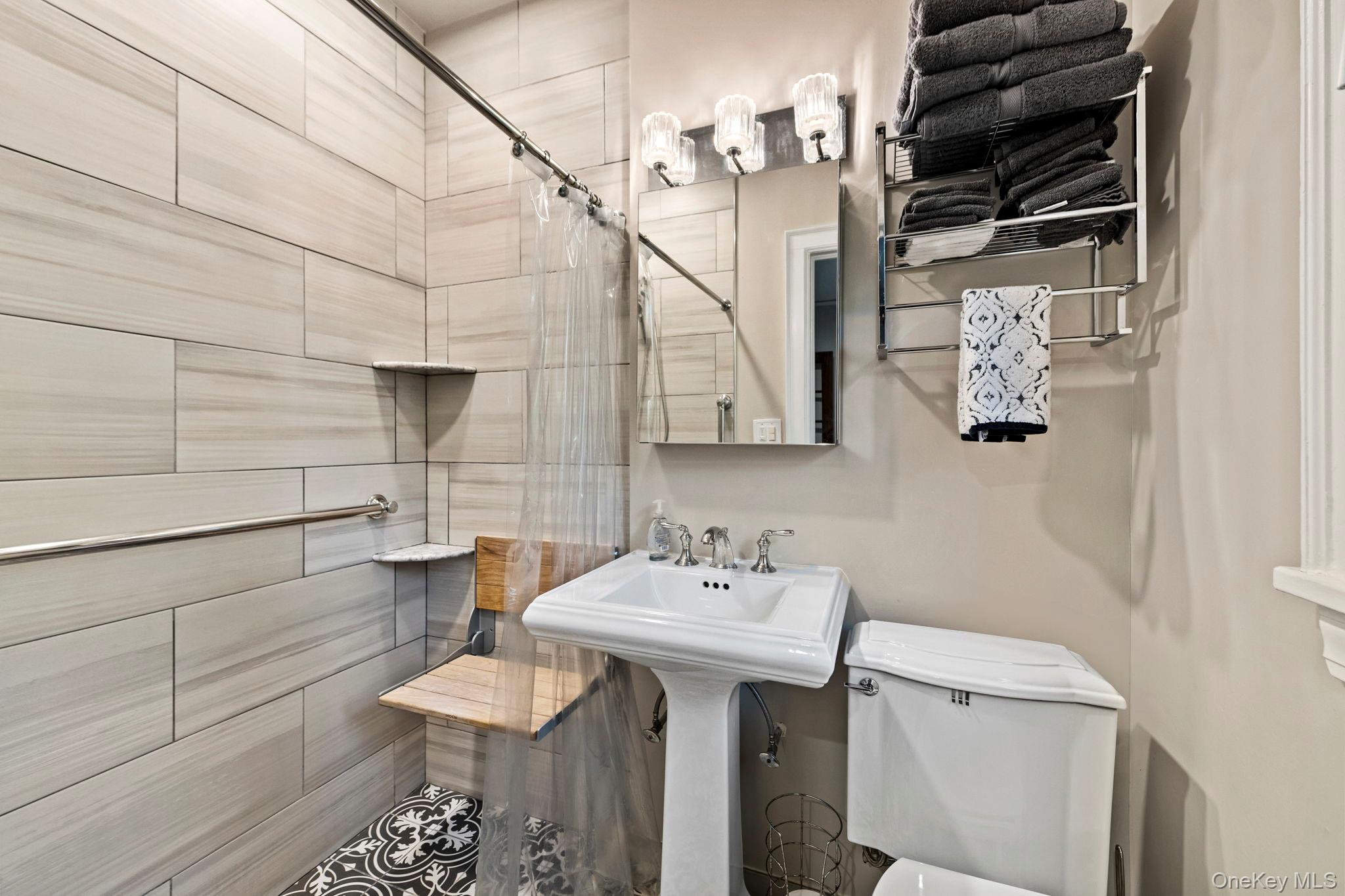 44 Fenimore Road New Rochelle, NY 10804 - Photo 15 of 46 a bathroom with a sink and a mirror