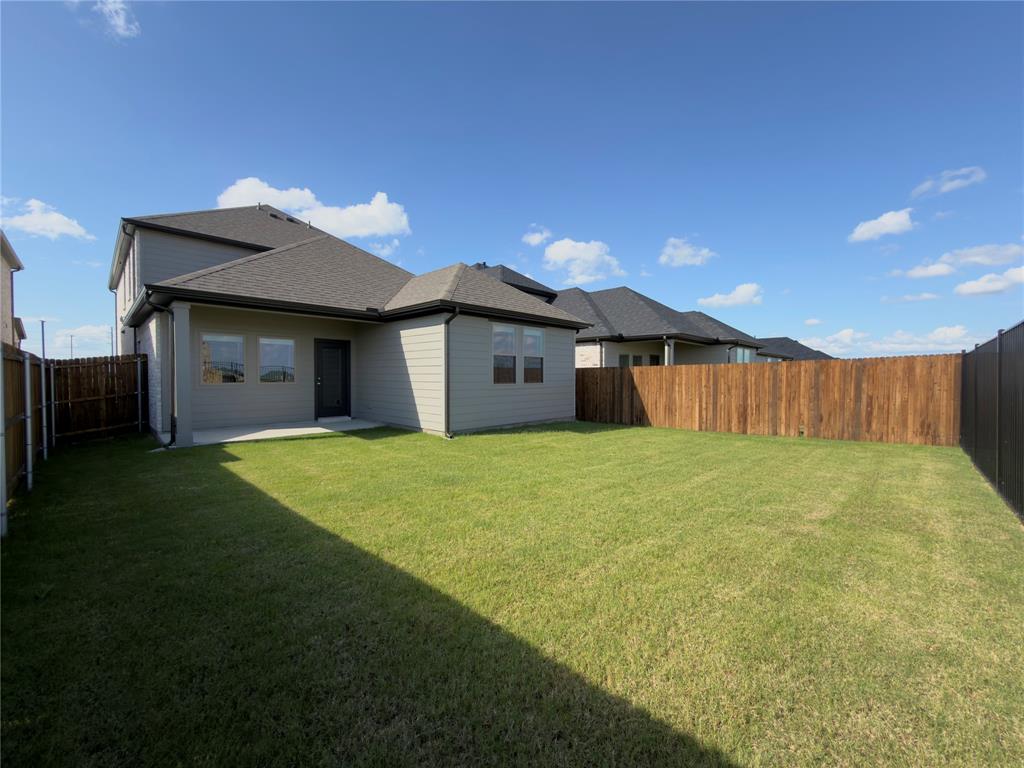 120 Millwood Road Lavon, TX 75166 - Photo 33 of 34 Expansive backyard featuring a manicured lawn, a covered concrete patio, and privacy fencing