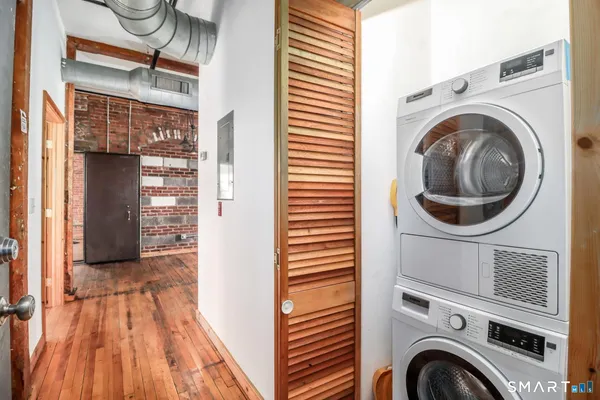 a view of a hallway with washer and dryer