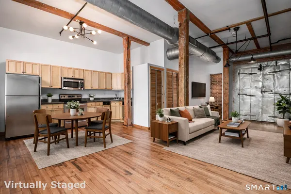 a view of a dining room with furniture wooden floor and a chandelier