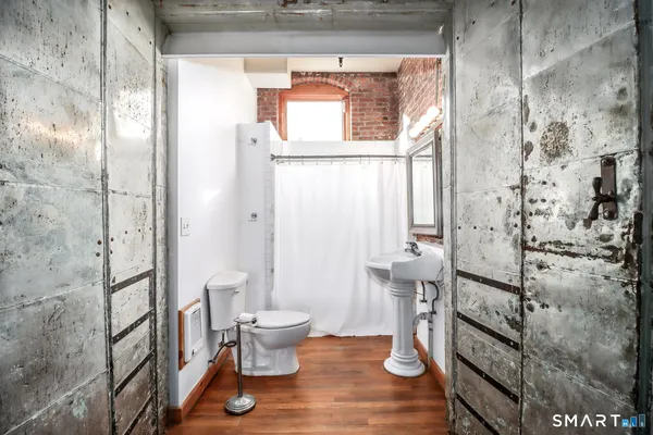 a bathroom with a toilet and a shower