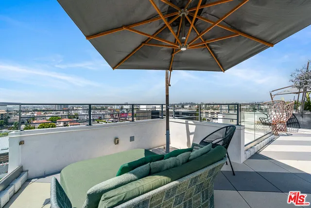 a living room with a couch and a bookshelf