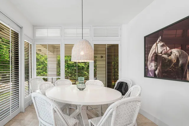 a view of a dining room with furniture large windows and wooden floor