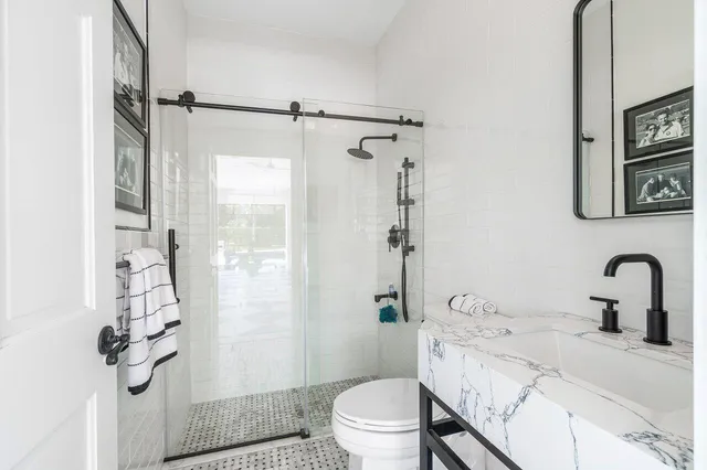 a living room with furniture a table and large windows